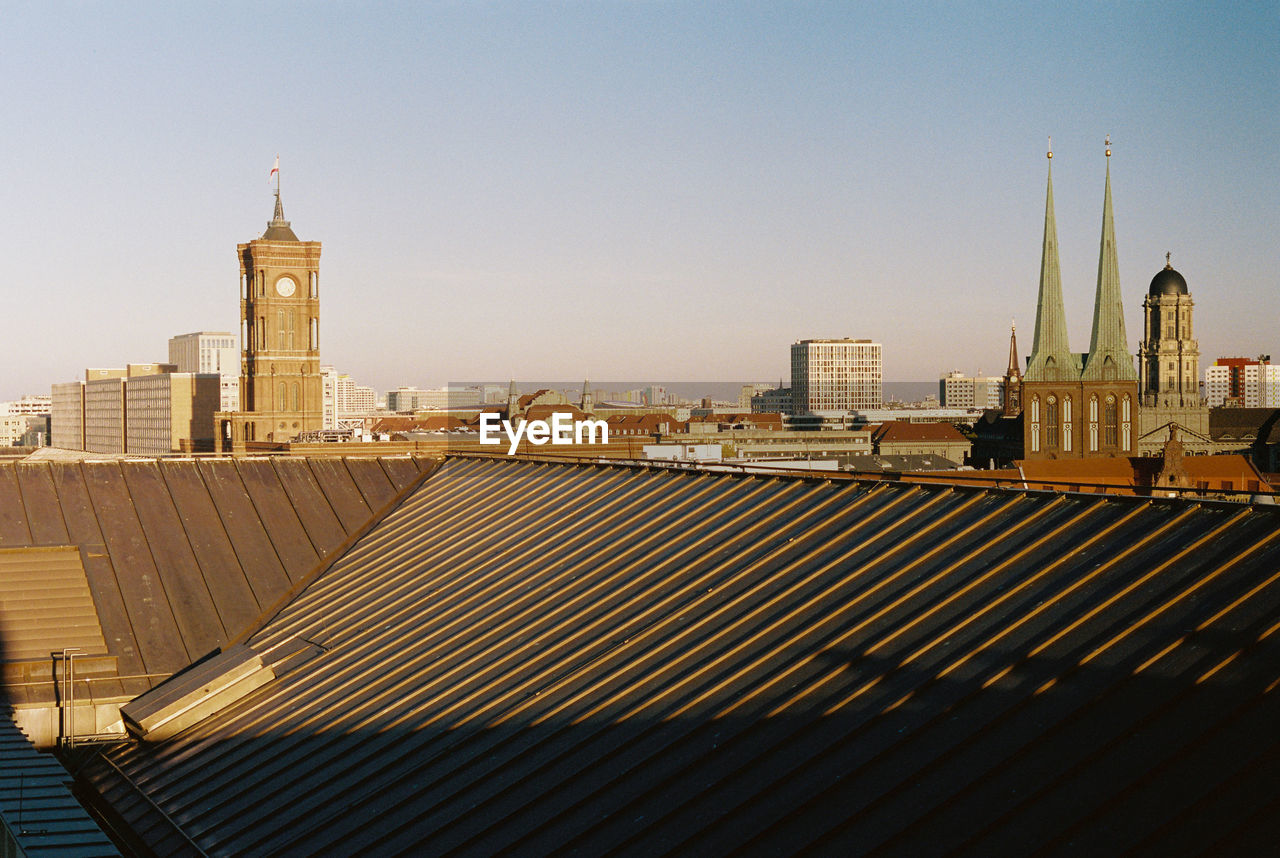 View of buildings in city against clear sky