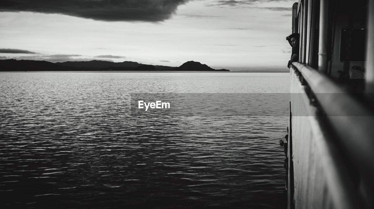 Close-up of boat sailing in sea against sky