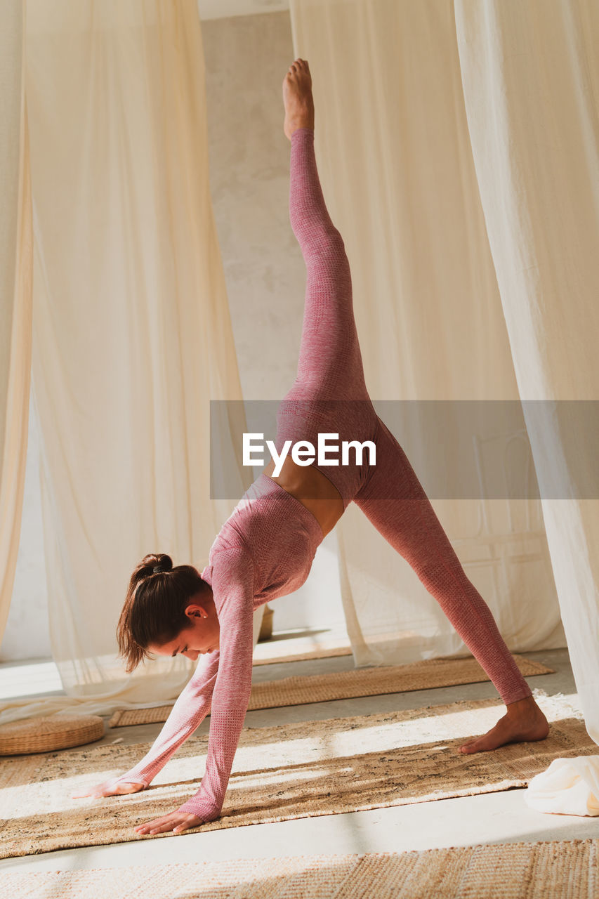 Young woman exercising at home