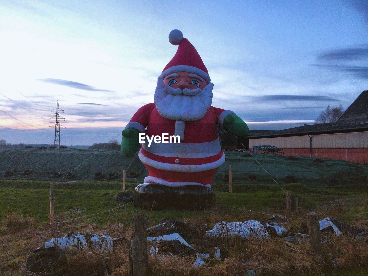 Santa claus on field against sky