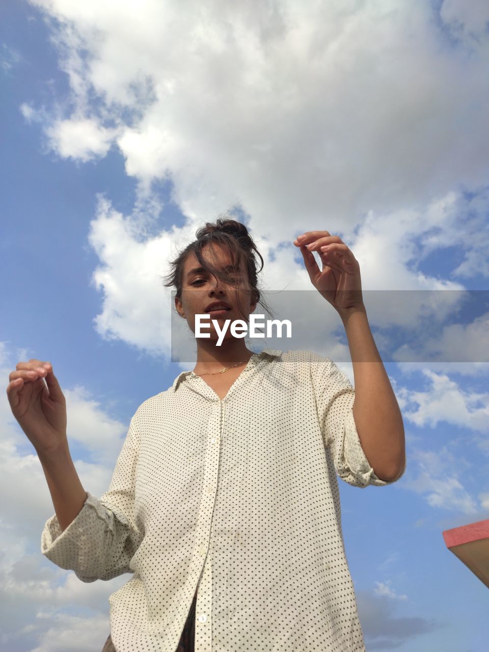 Low angle view of woman against sky