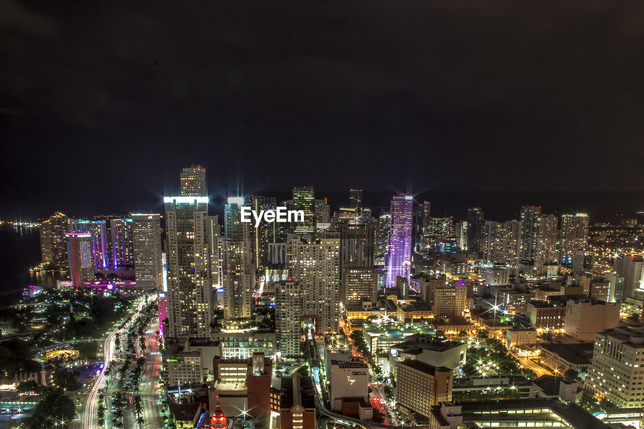 High angle view of illuminated residential district against clear sky