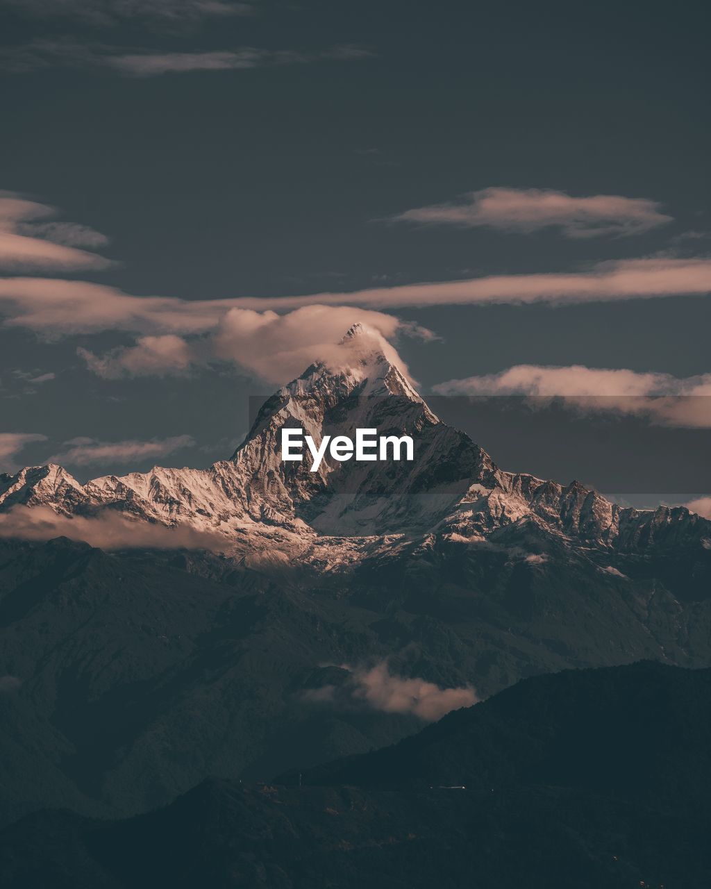 Aerial view of snowcapped mountains against sky during winter