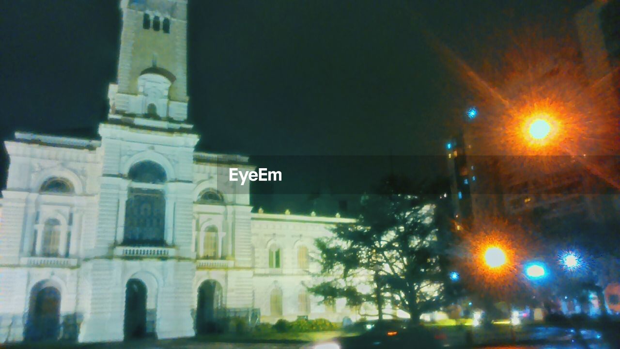 VIEW OF ILLUMINATED CITY AT NIGHT