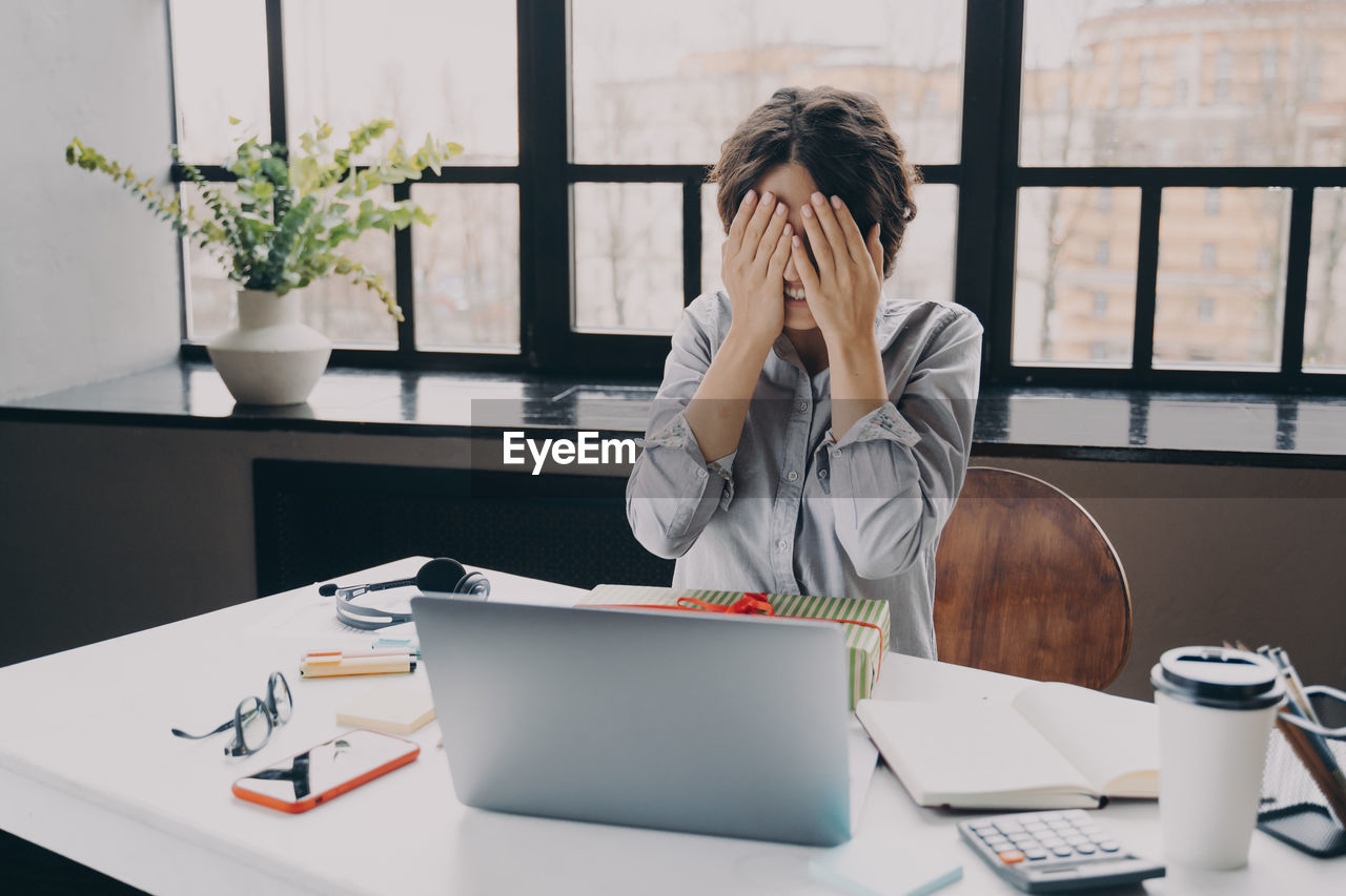 young woman using laptop on table at office