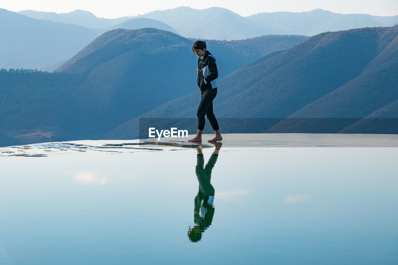 FULL LENGTH OF MAN STANDING ON MOUNTAIN