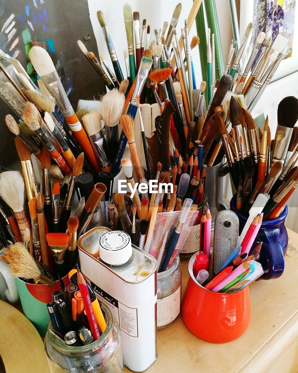High angle view of paintbrushes and pencils on table