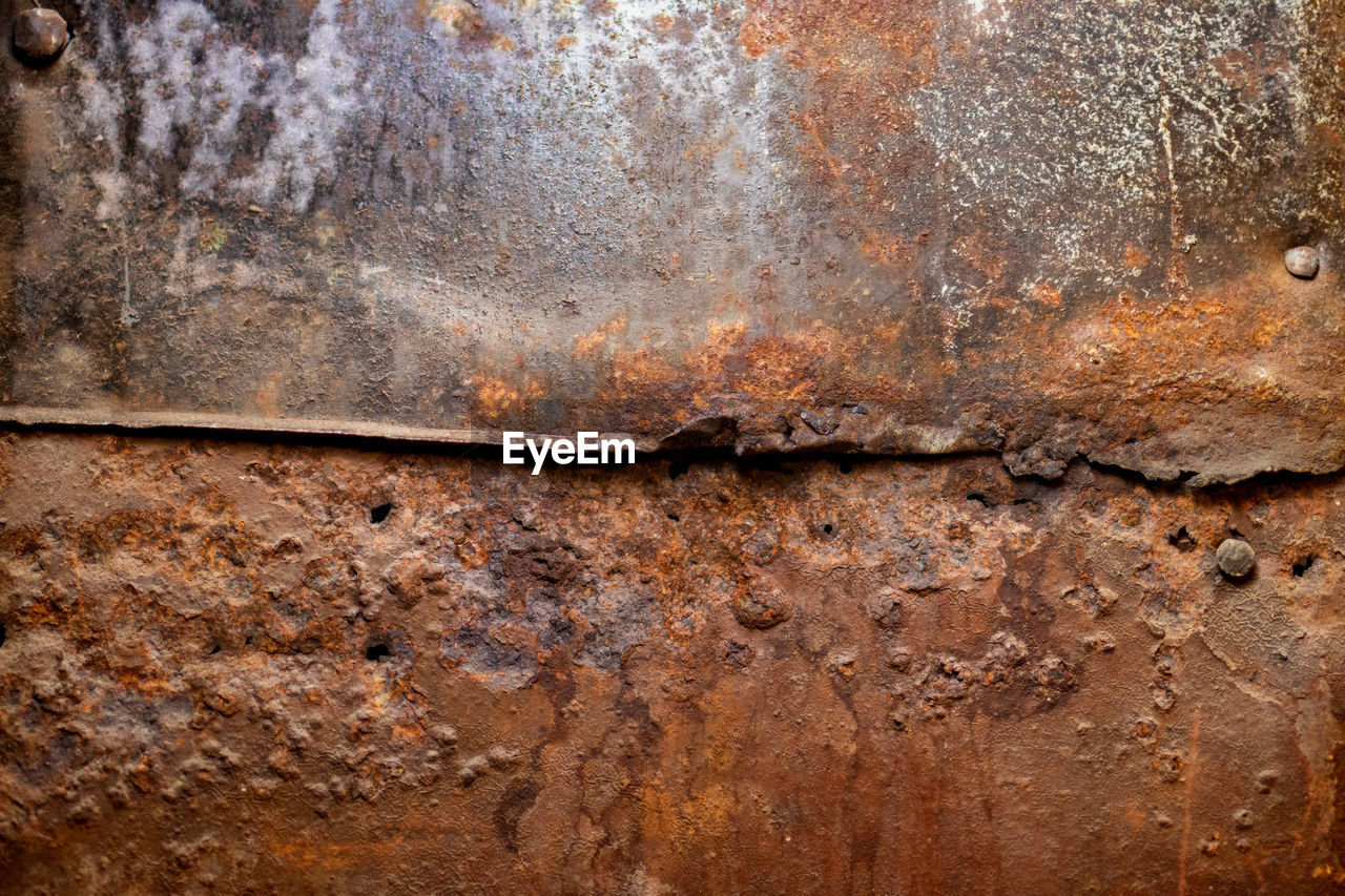 Full frame shot of rusty metal wall in 1890s apartment building 