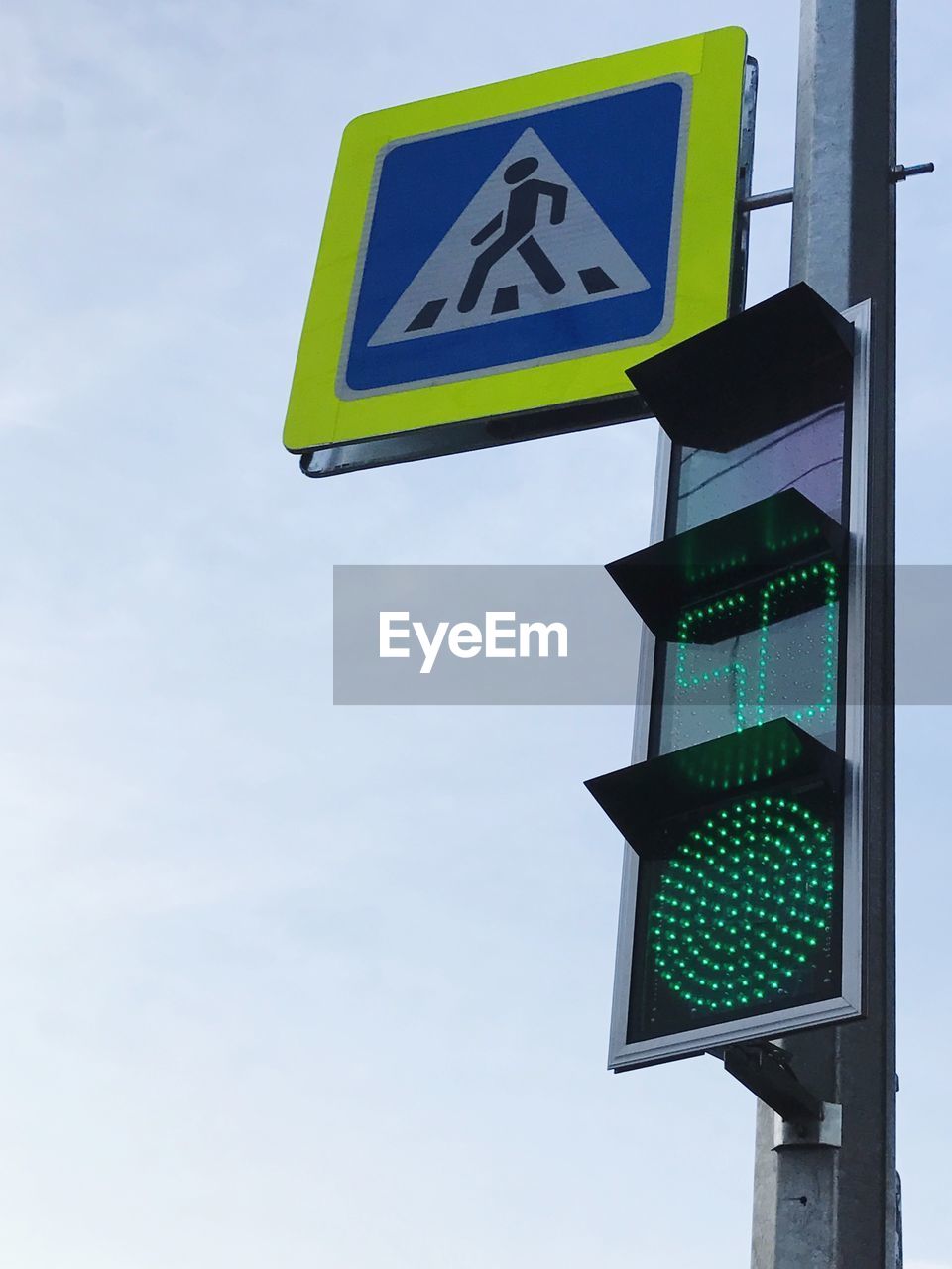 Low angle view of road signal against sky