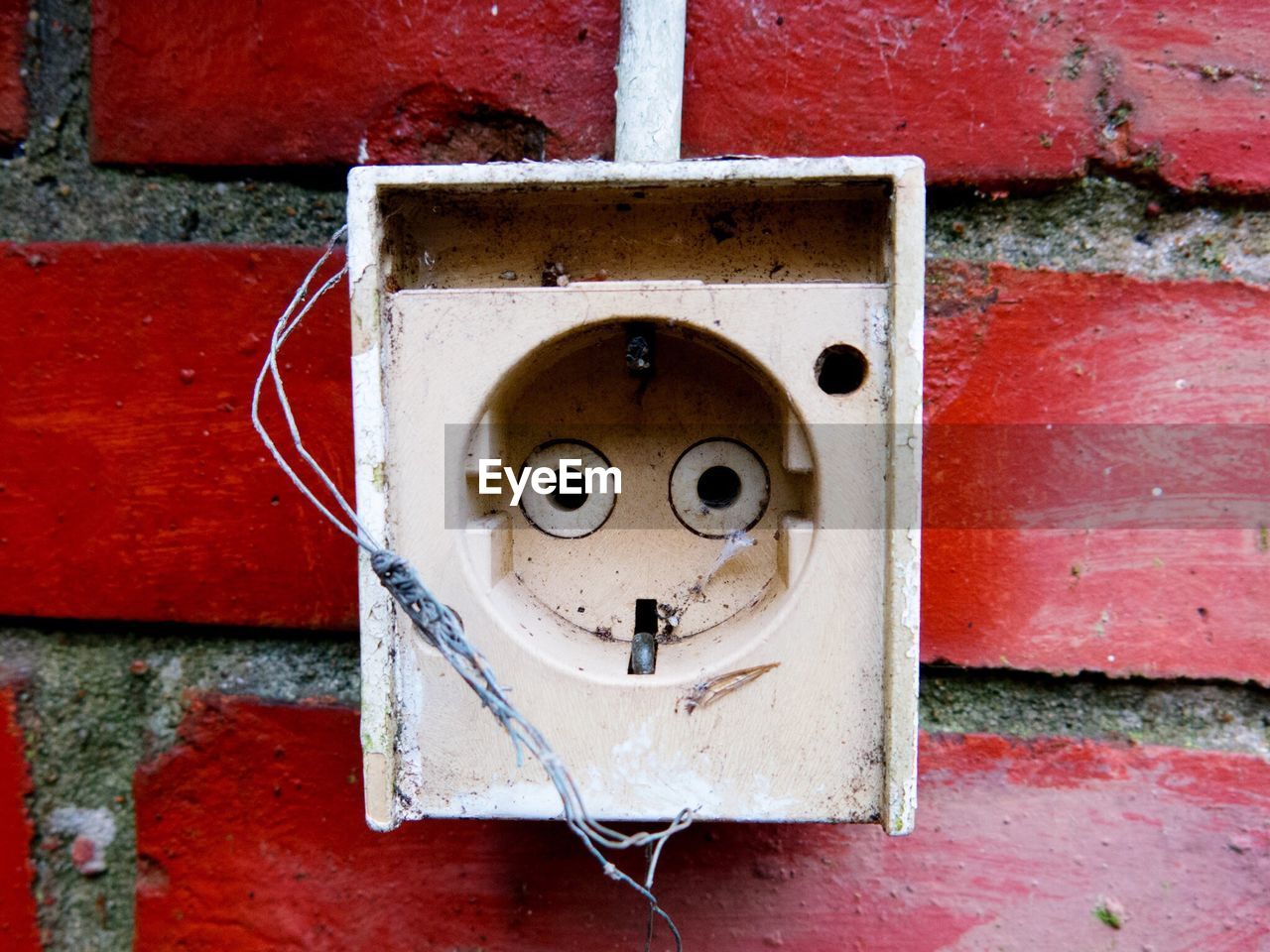 Close-up of sign on brick wall