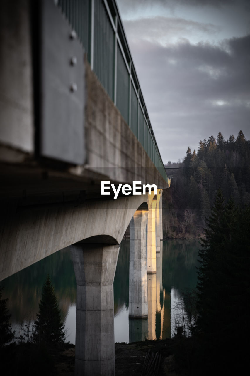 Low angle view of bridge over river against sky