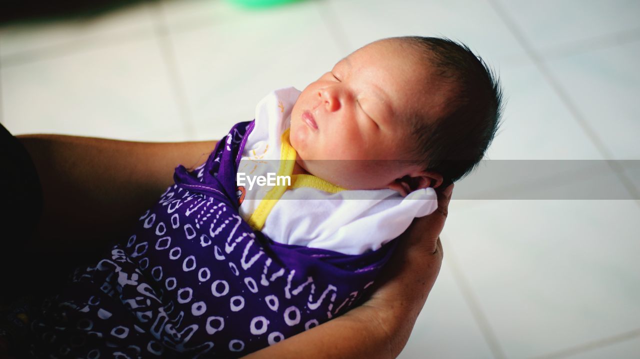 High angle view of cute baby sleeping