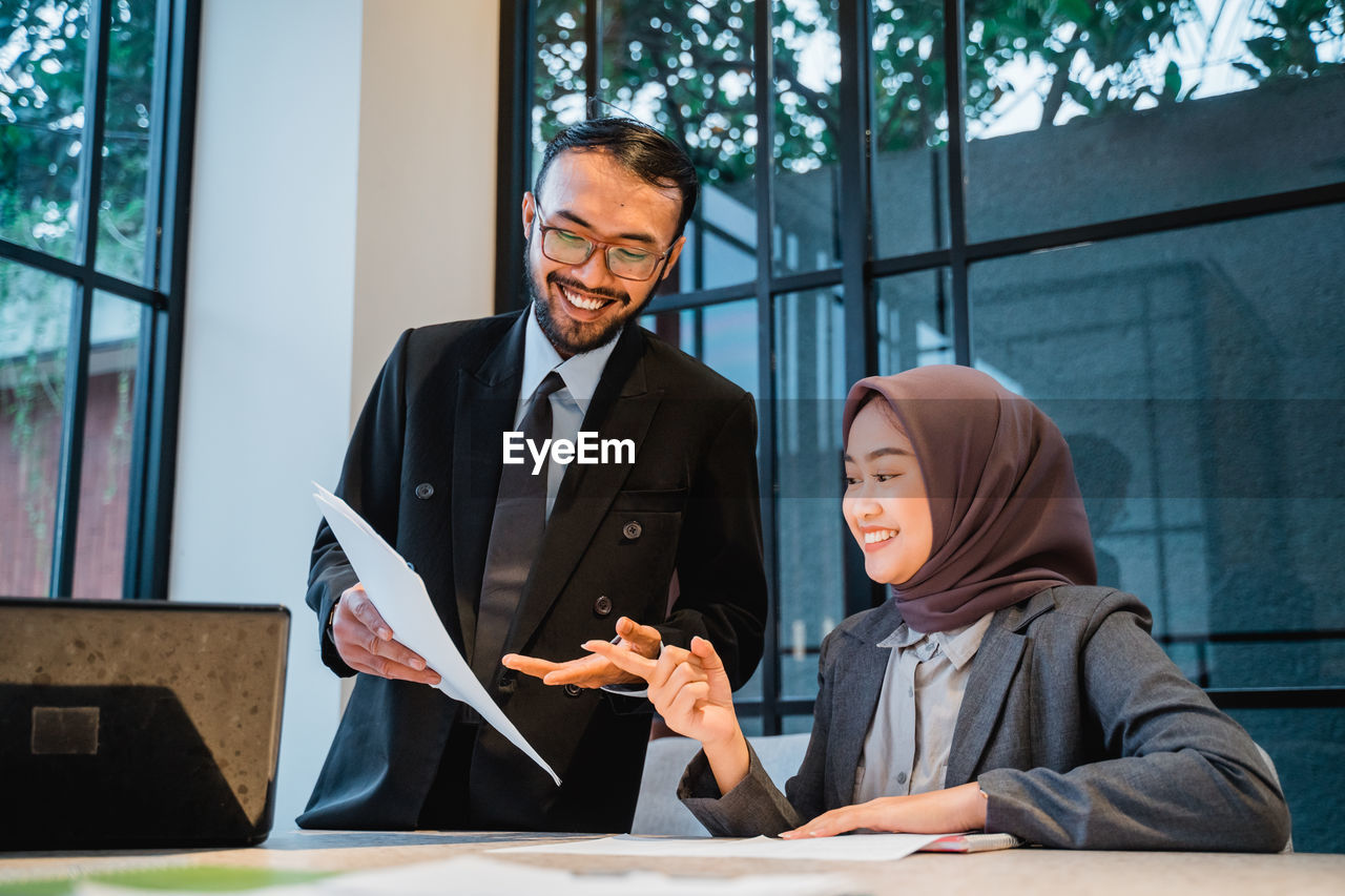 High angle view of smiling man talking with woman