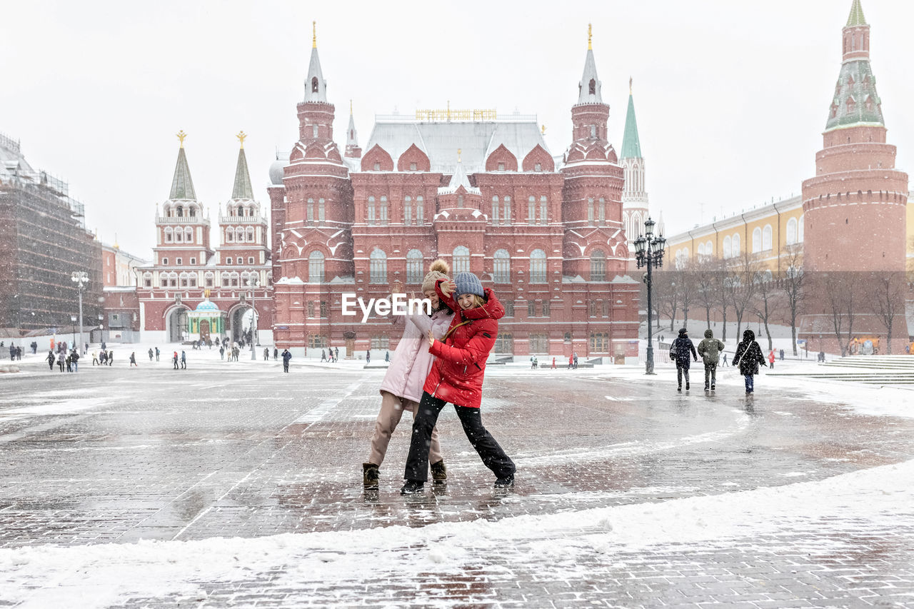 PEOPLE ON SNOW COVERED CITY DURING WINTER