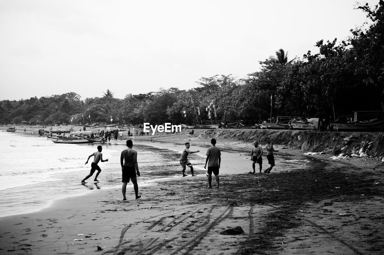 GROUP OF PEOPLE PLAYING SOCCER ON FIELD