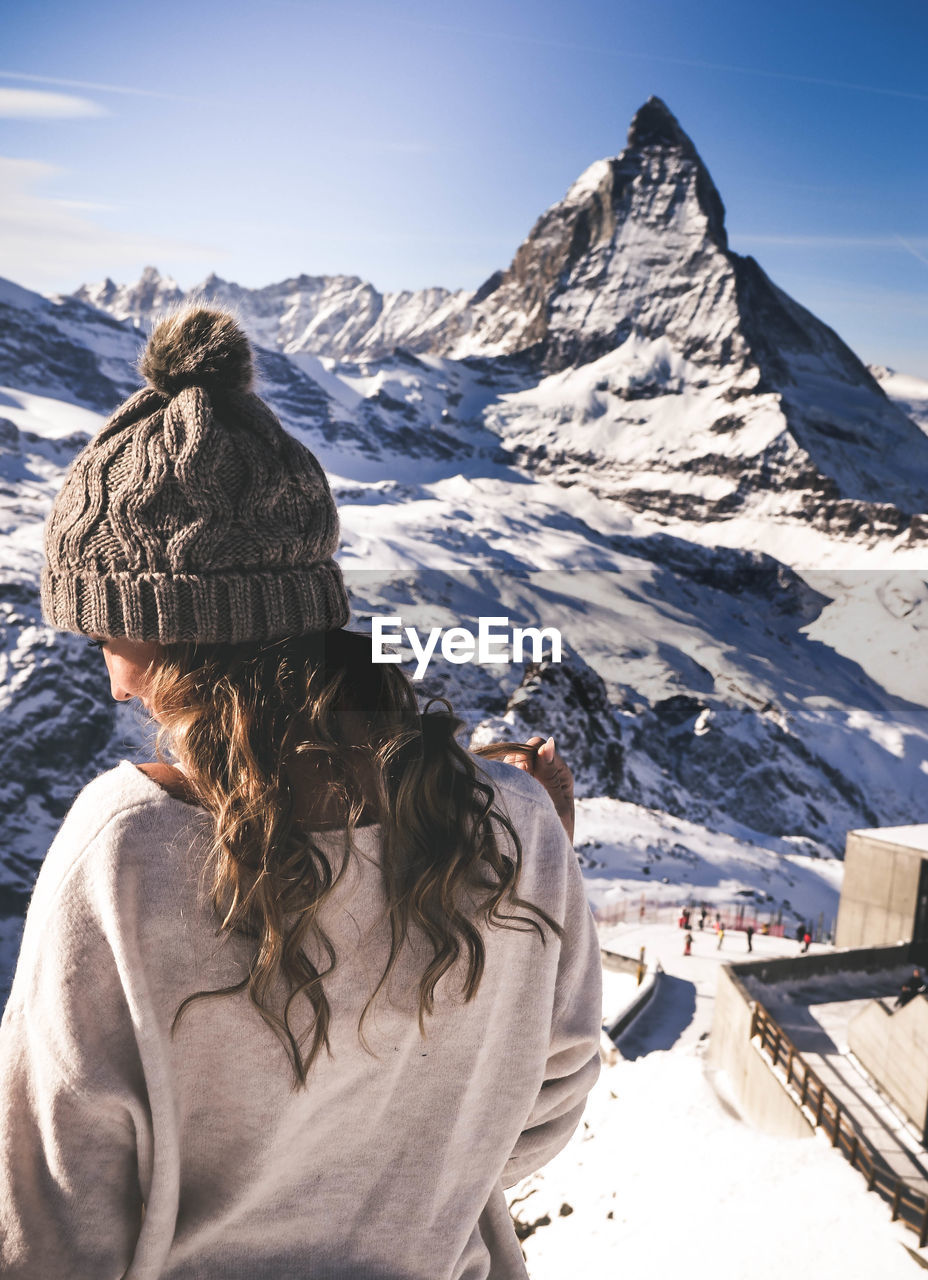 Rear view of woman on snowcapped mountain