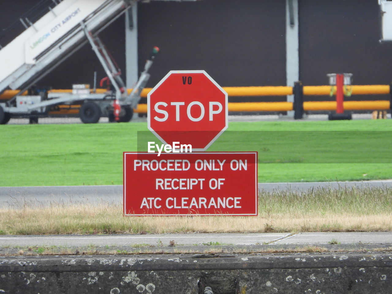 Close-up of stop sign on airport runway