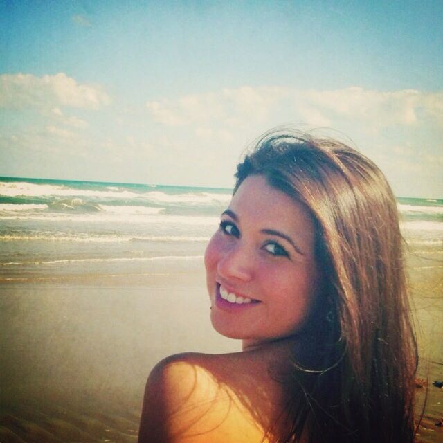 WOMAN STANDING ON BEACH