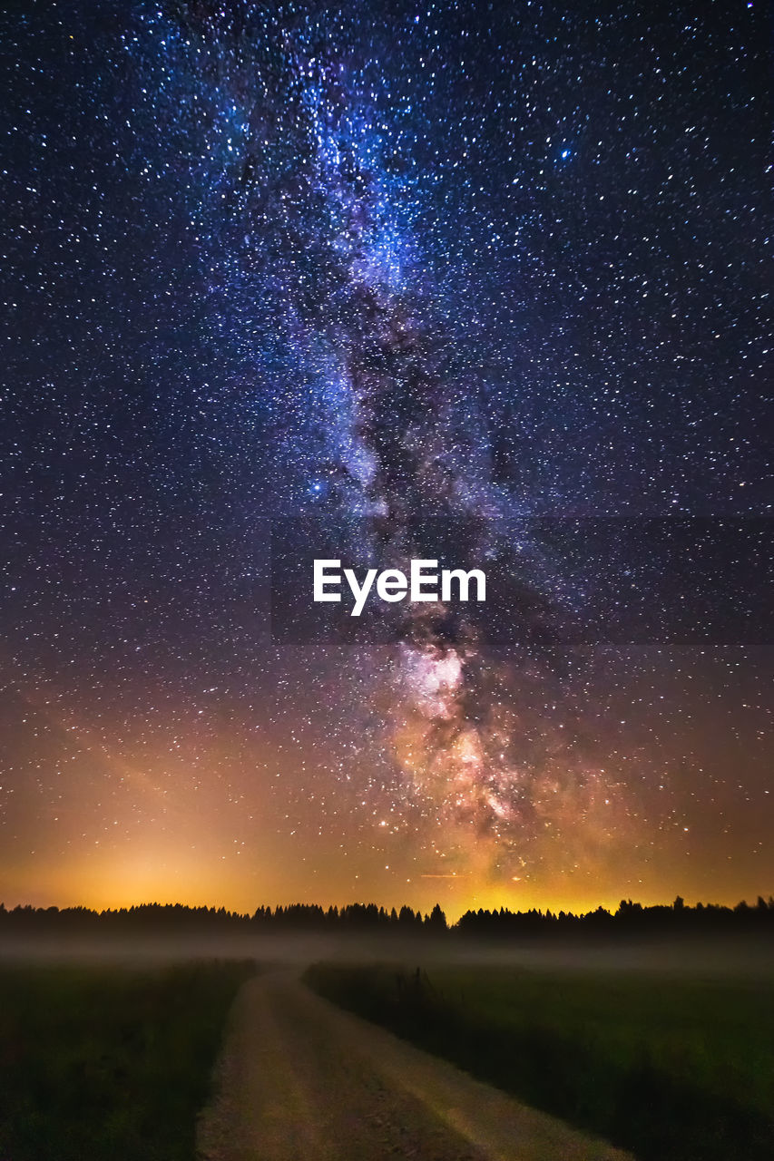 Scenic view of field against sky at night