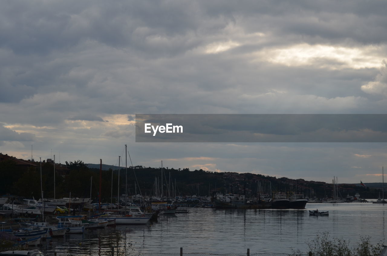 BOATS IN HARBOR AT SUNSET