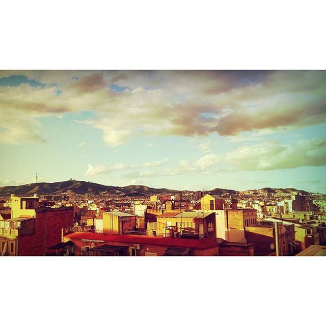 TOWNSCAPE AGAINST CLOUDY SKY