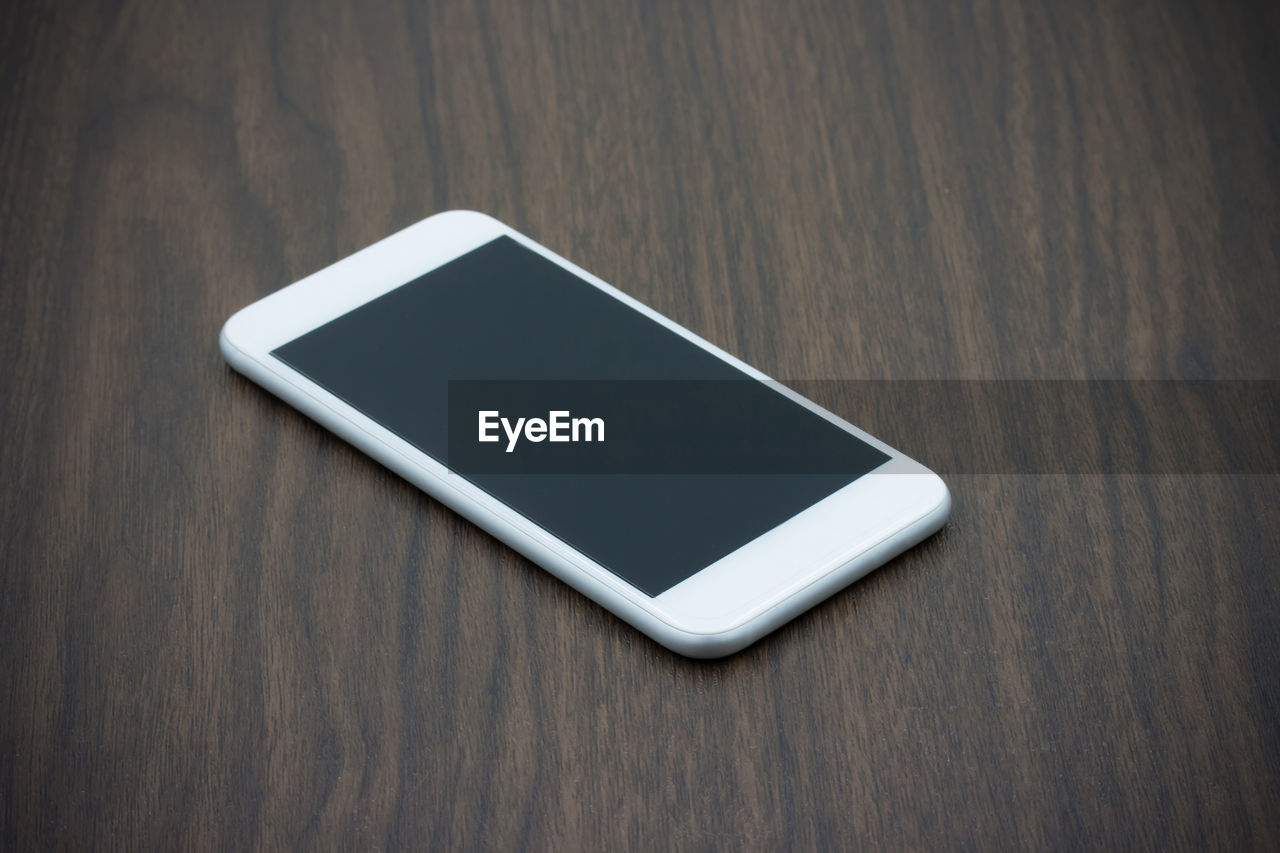 Close-up of smart phone on wooden table