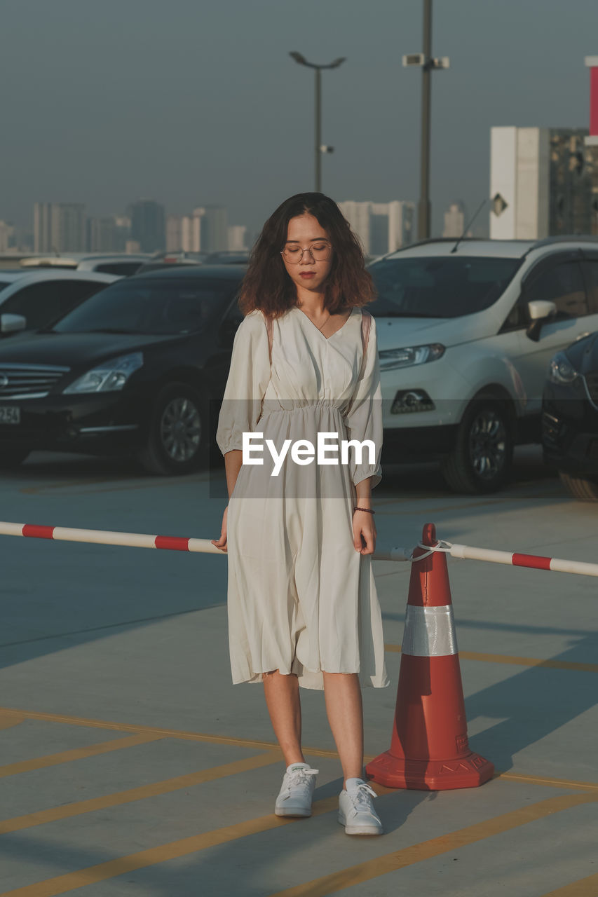 Portrait of young woman standing on street