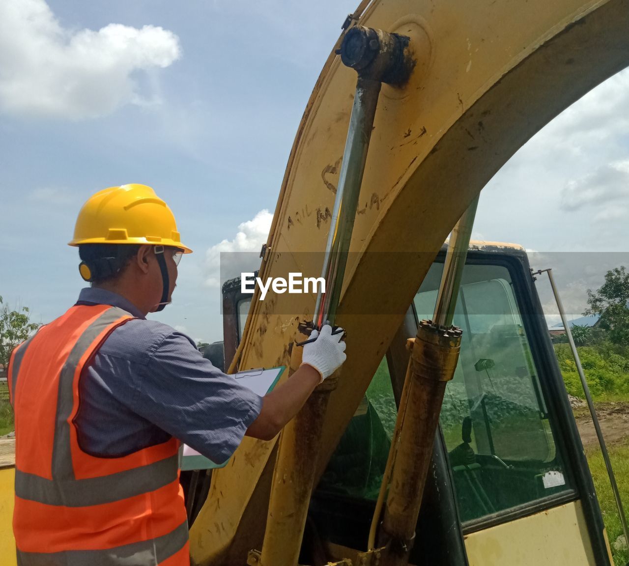 LOW ANGLE VIEW OF MAN WORKING ON BRIDGE