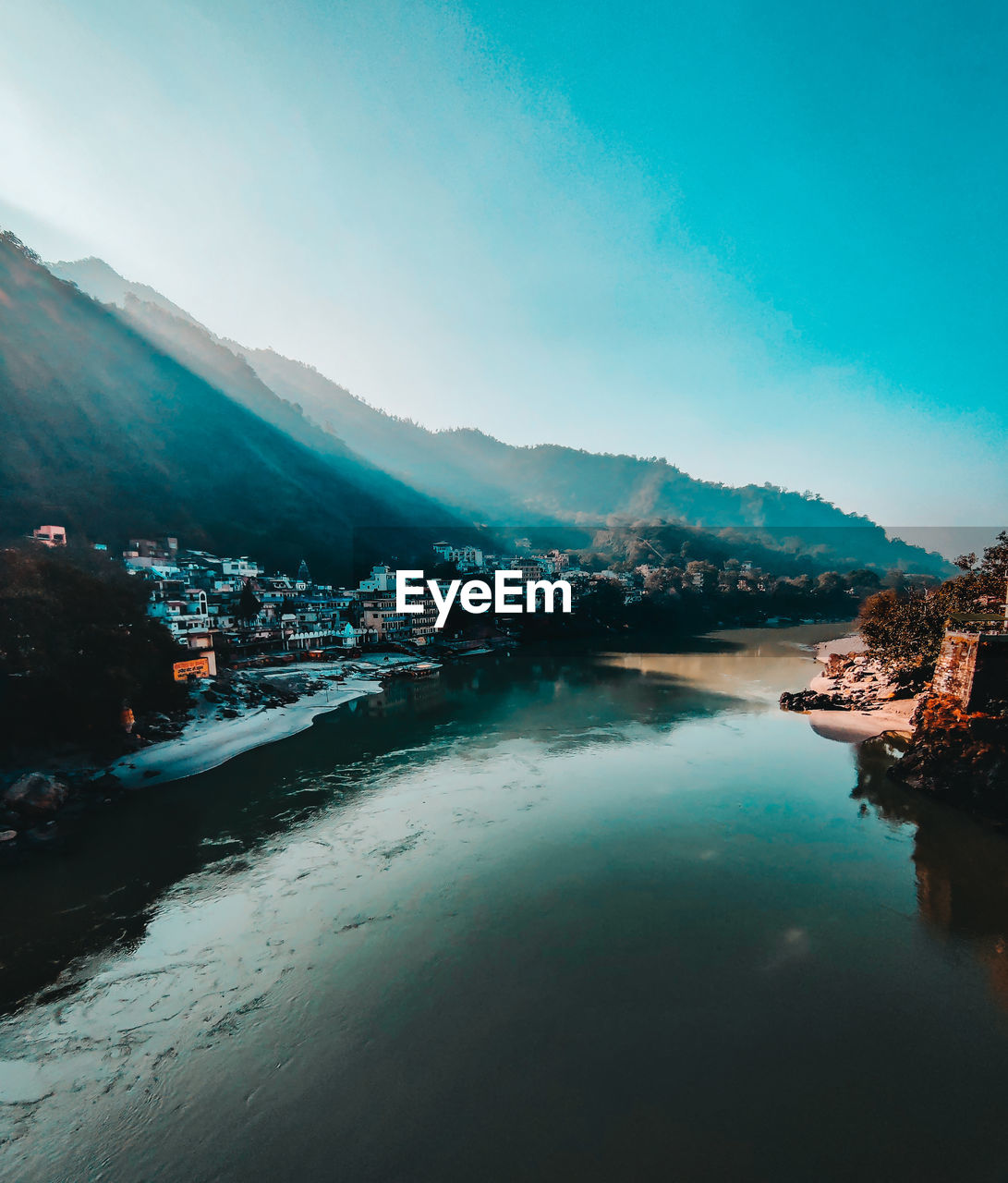 Scenic view of river ganga against the morning mist and hills of beautiful city of rishikesh, india 