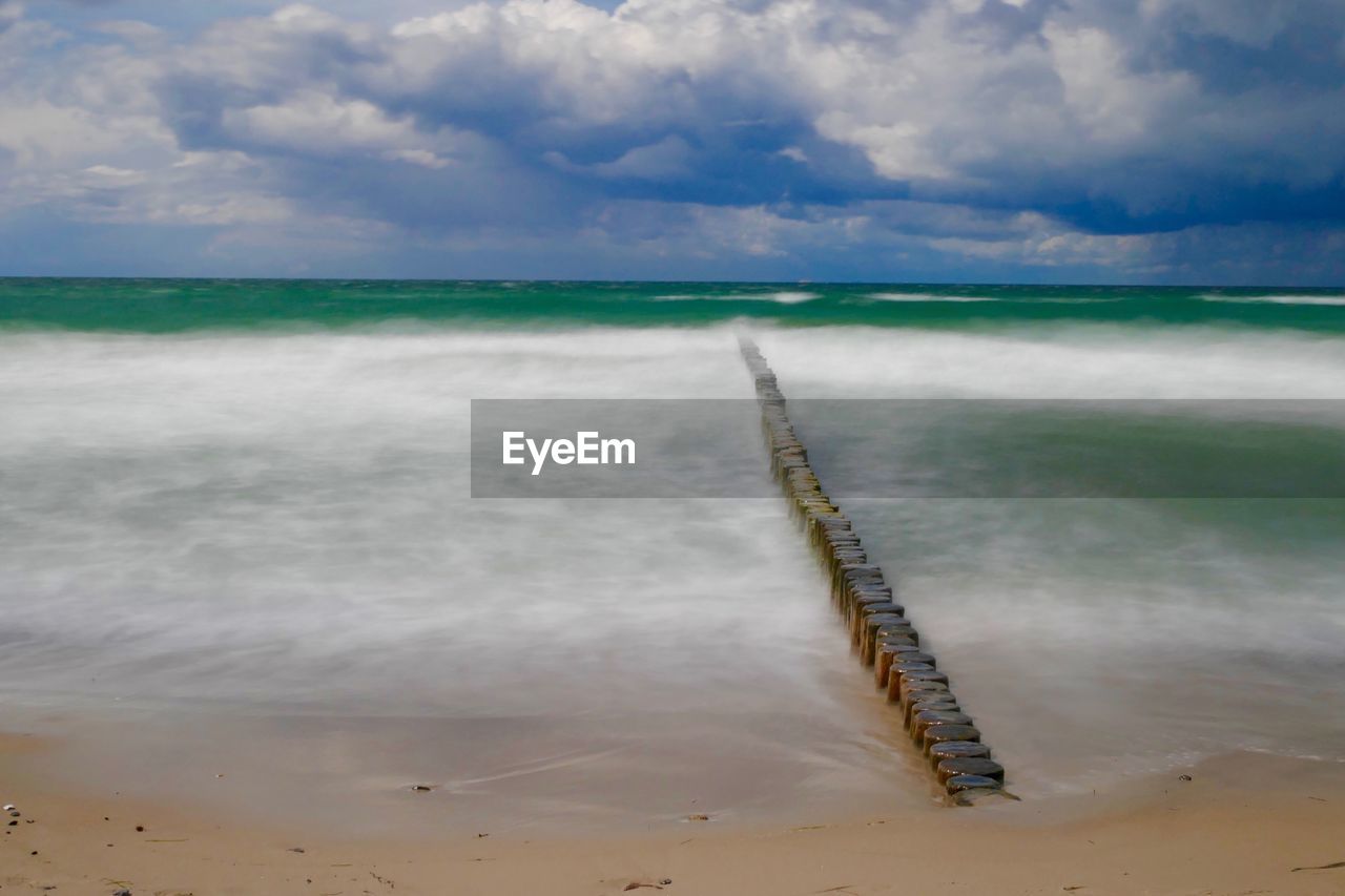 VIEW OF SEA AGAINST CLOUDY SKY