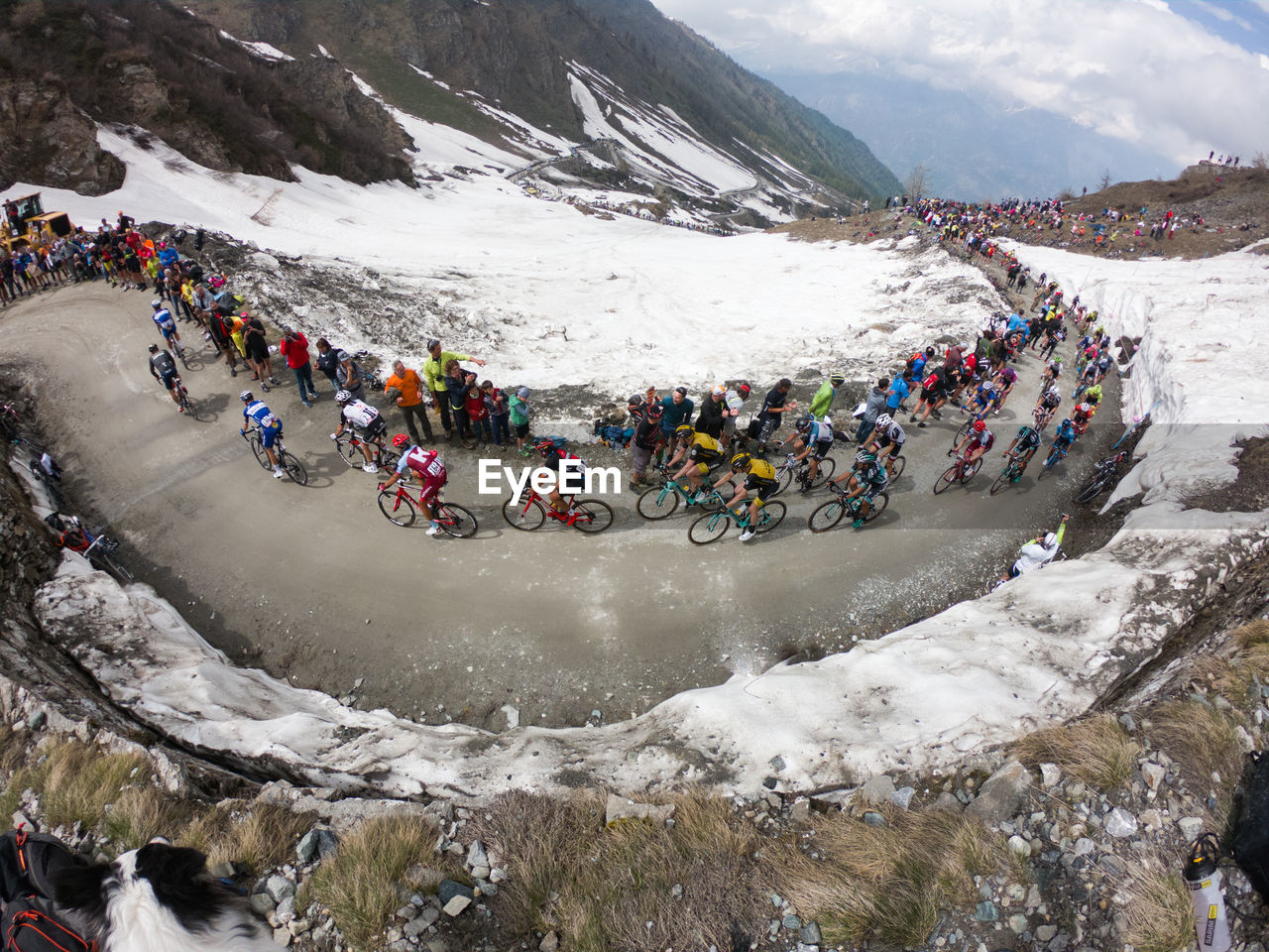 HIGH ANGLE VIEW OF PEOPLE ON SNOWCAPPED MOUNTAIN