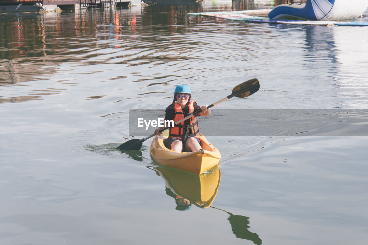 Woman kayaking in lake