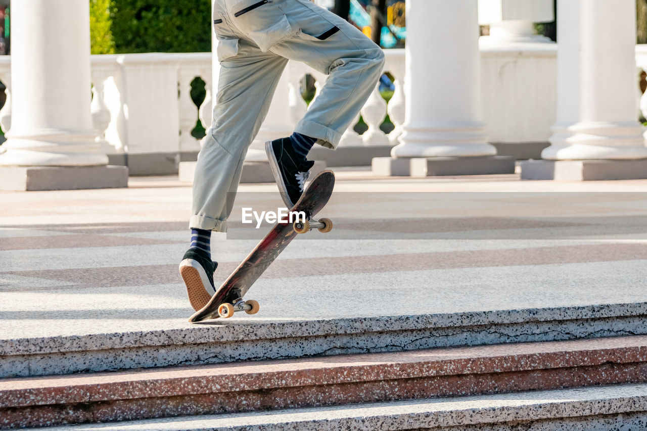 Low section of man skateboarding on skateboard