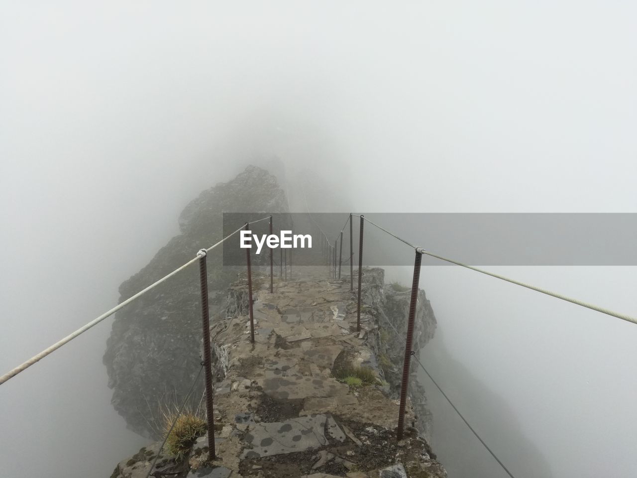 HIGH ANGLE VIEW OF BRIDGE IN FOGGY WEATHER