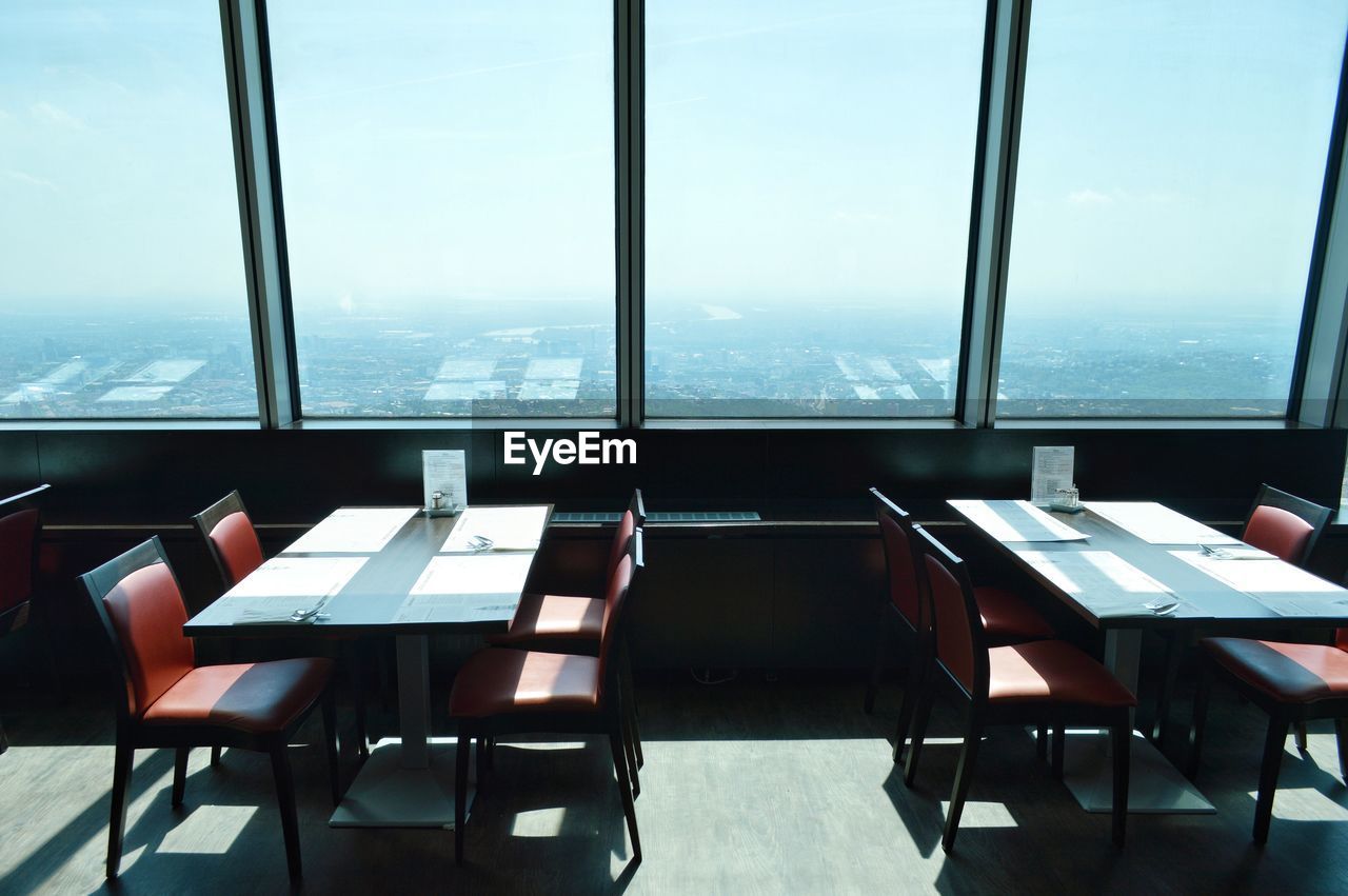 Empty chairs and tables in restaurant