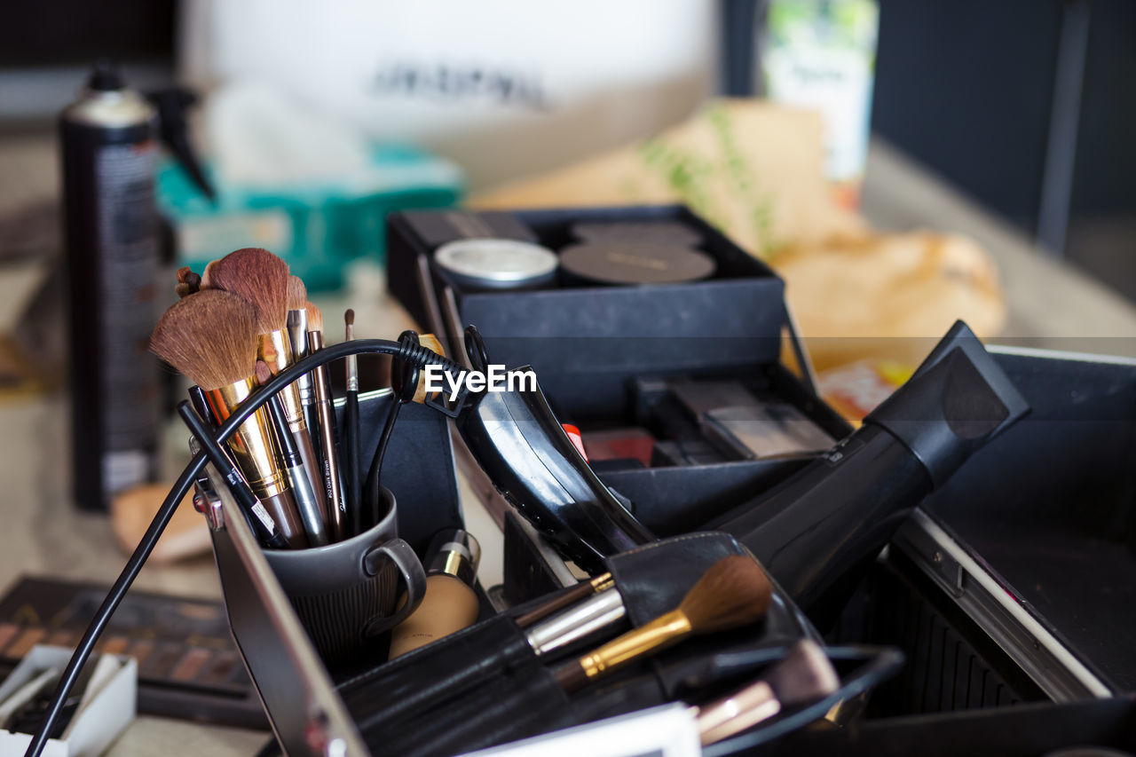 Dedicated focus make-up converter on makeup artist's table with lots of makeup artist tools.