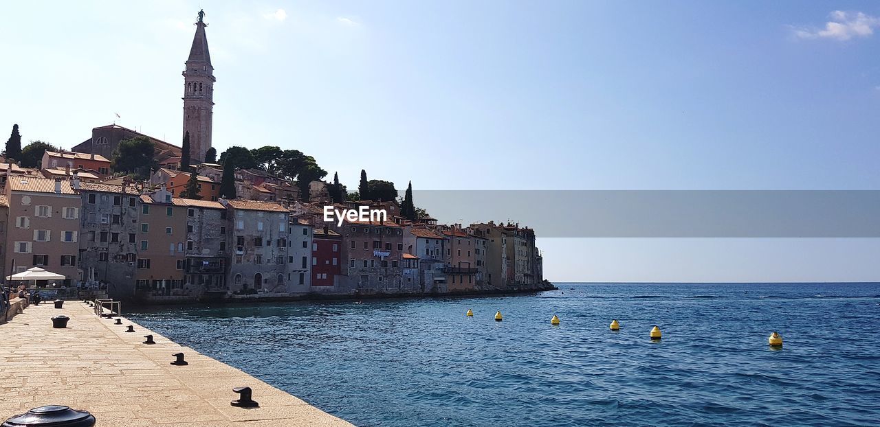 View of building by sea against clear sky