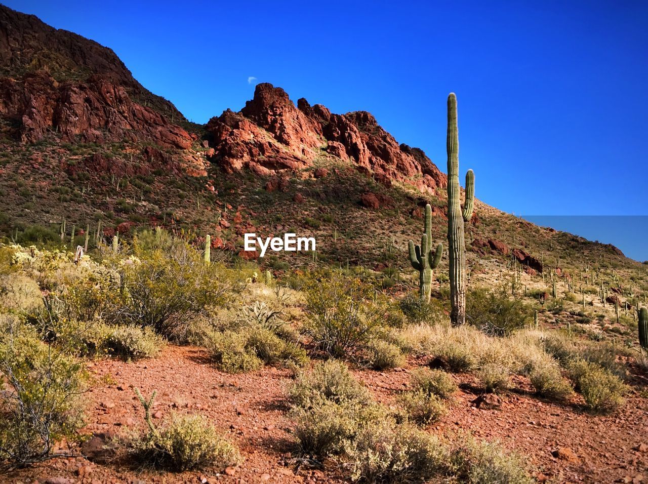 Scenic view of mountains against blue sky