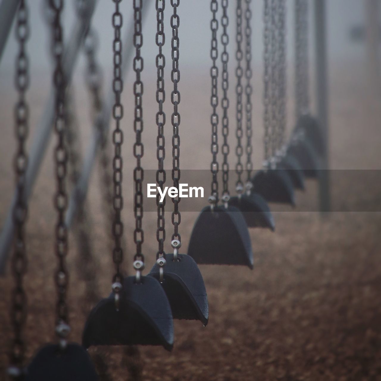 Close-up of empty swings at playground