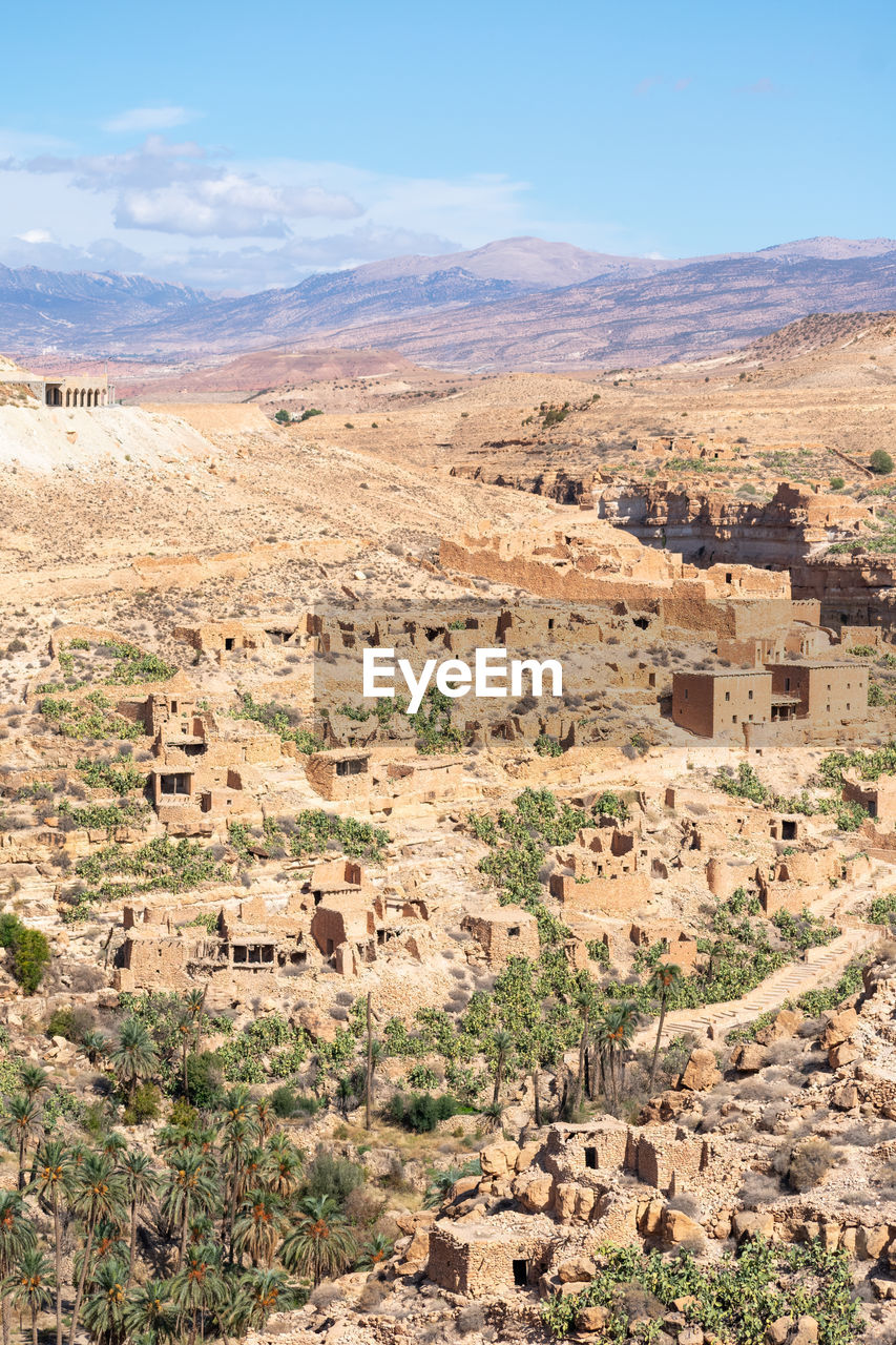 Scenic view of old stone houses, palm trees ghoufi canyon in the aures region, algeria