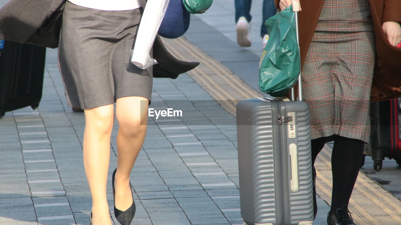 Low section of people walking on street