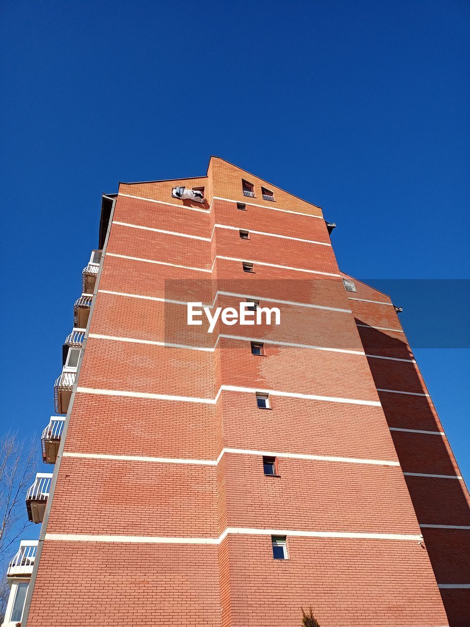 Low angle view of building against clear blue sky