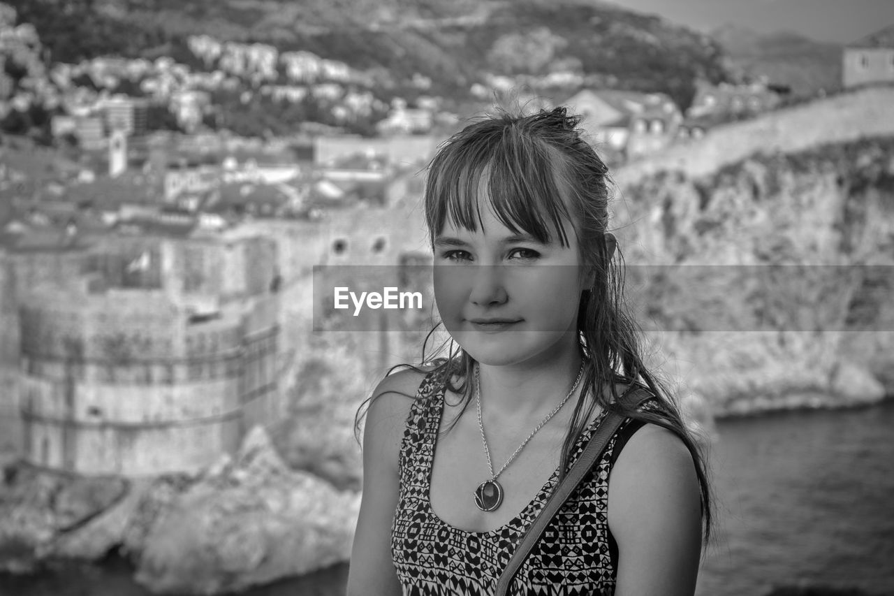 Portrait of girl standing against mountain