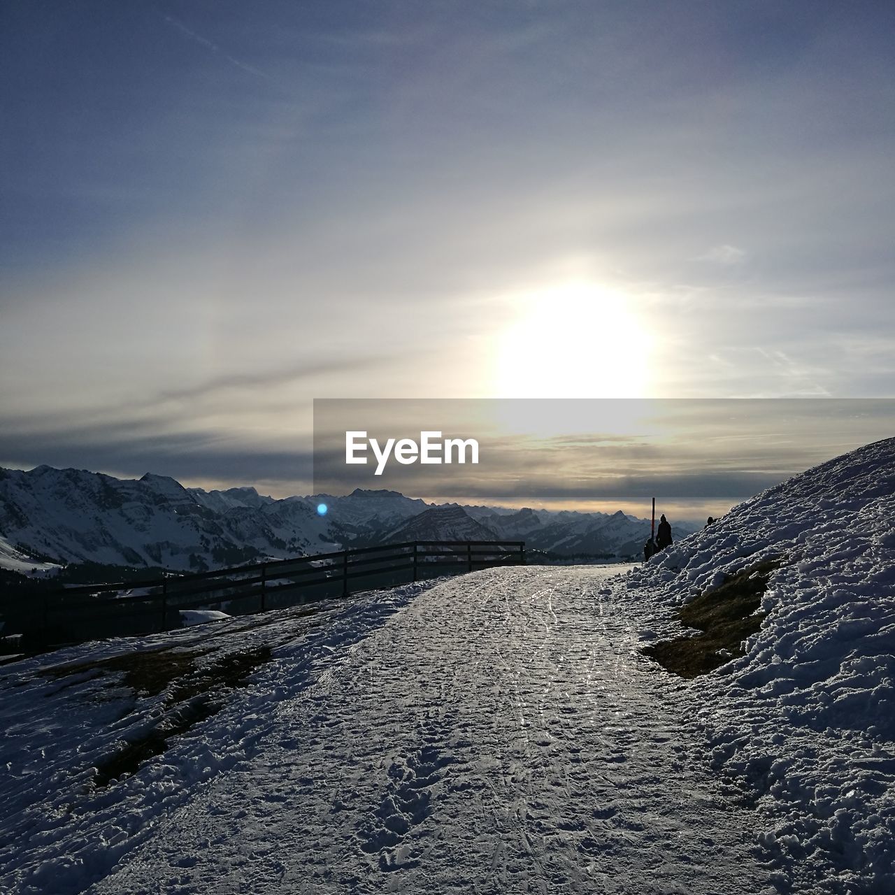 Scenic view of snowcapped mountains against sky during sunset