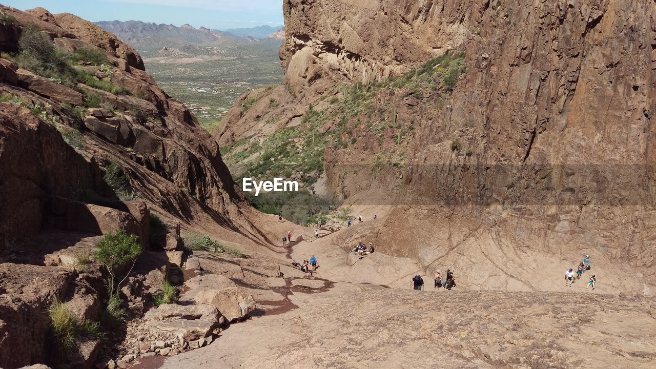 GROUP OF PEOPLE ON ROCK