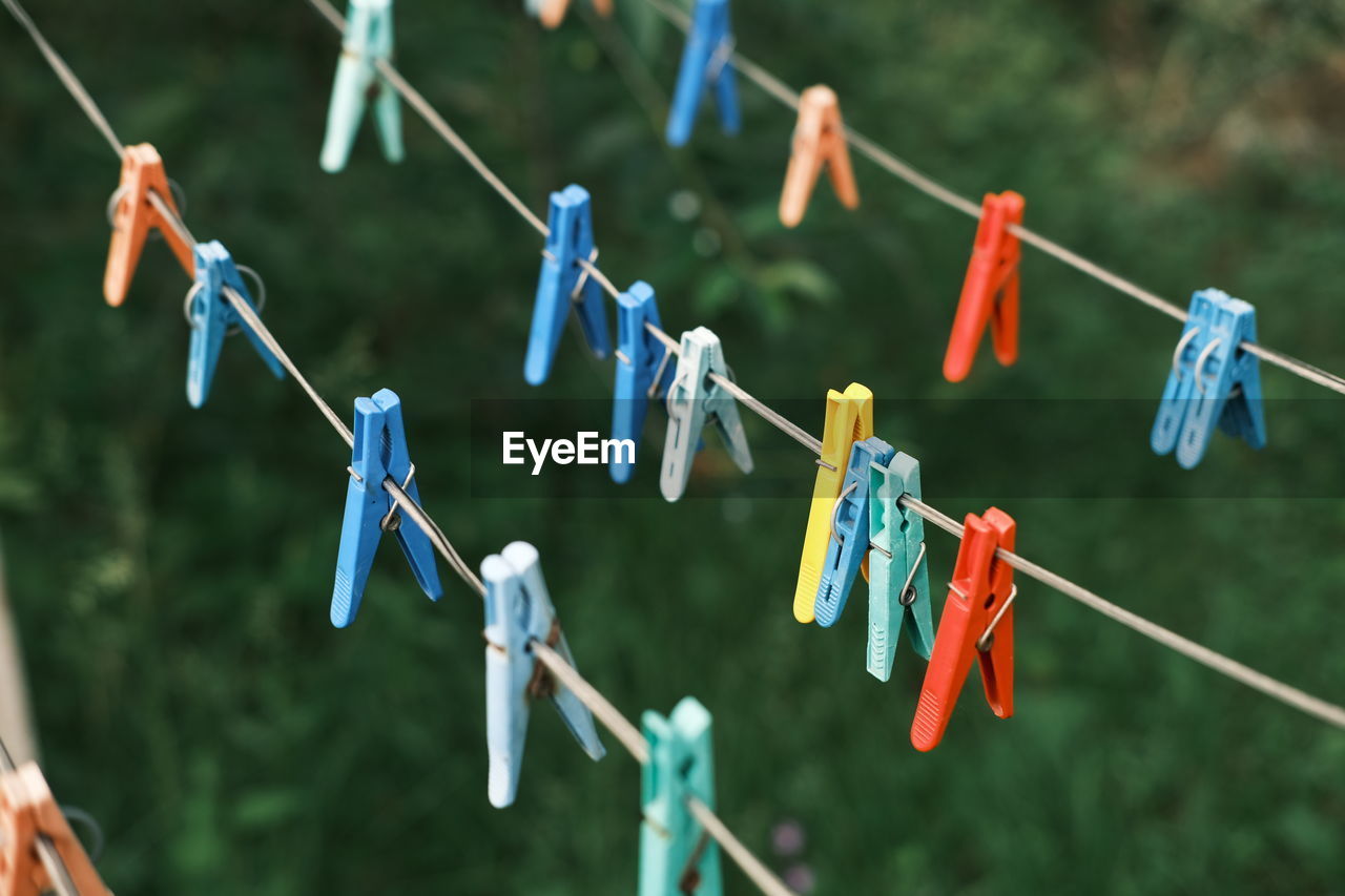 CLOSE-UP OF MULTI COLORED HANGING ON CLOTHESLINE