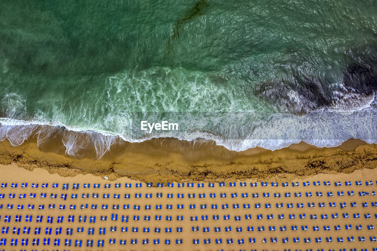 Aerial view of deck chairs arranged on beach