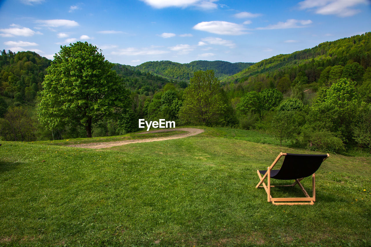 Scenic view of green landscape against sky