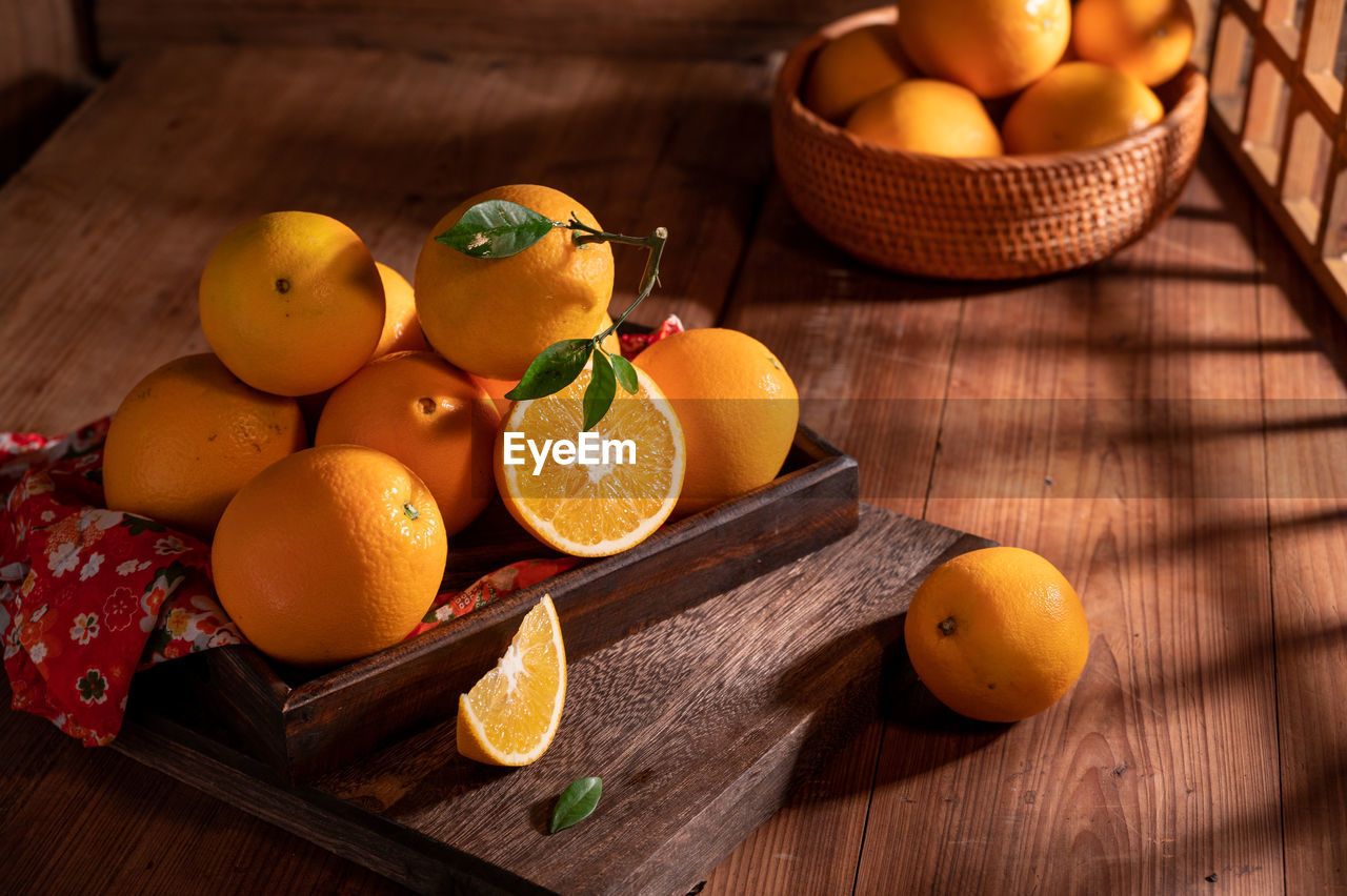 food and drink, food, fruit, healthy eating, citrus fruit, tangerine, orange, produce, wellbeing, clementine, citrus, freshness, wood, grapefruit, blood orange, orange color, plant, no people, lemon, basket, container, yellow, still life, indoors, nature, rustic, still life photography, table, high angle view