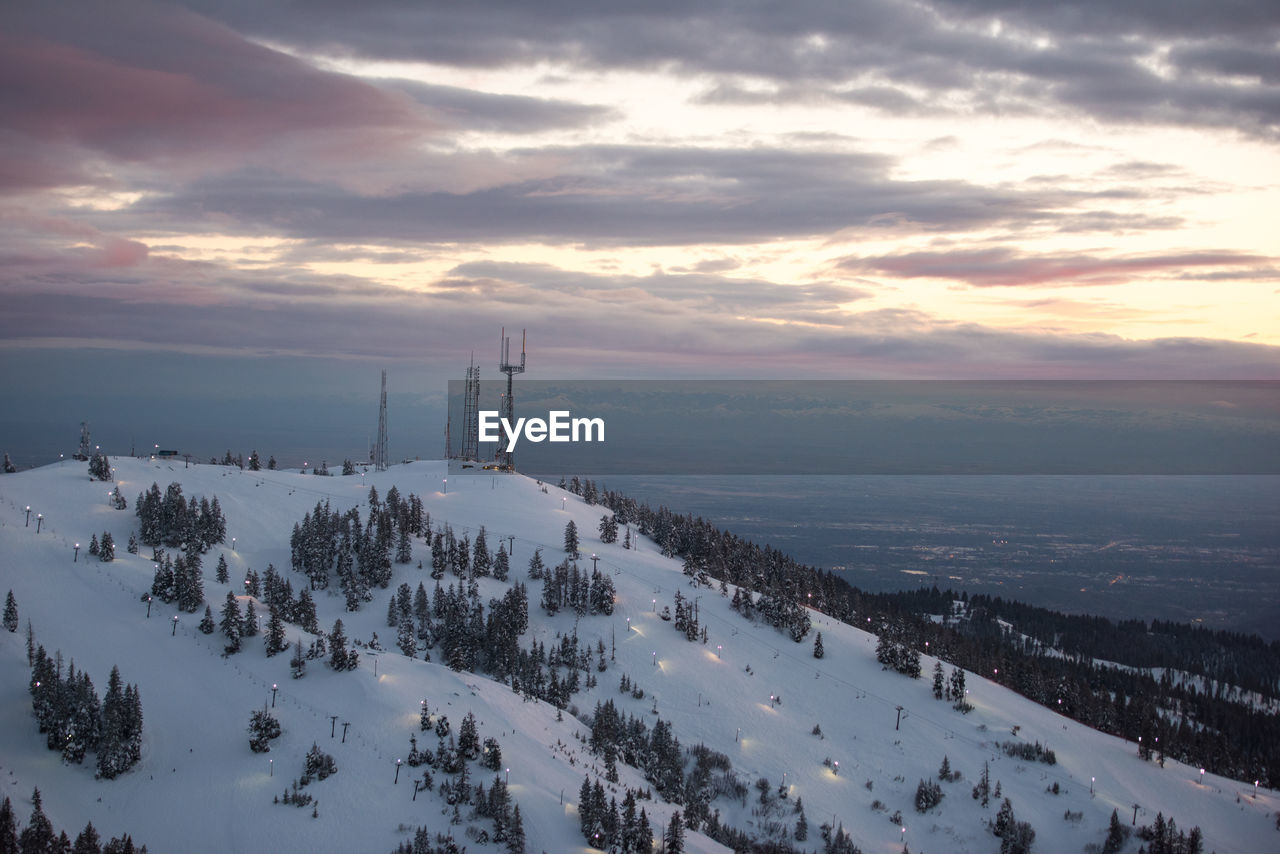 High angle view of snow covered mountain against sky